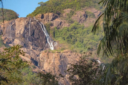 Picturesque view of a waterfalling caseding through big rocks - hidden waterfalls in Goa