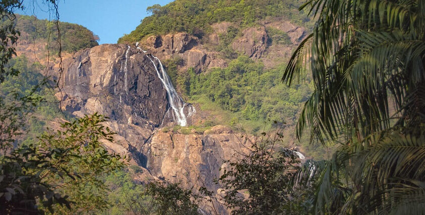 Picturesque view of a waterfalling caseding through big rocks - hidden waterfalls in Goa