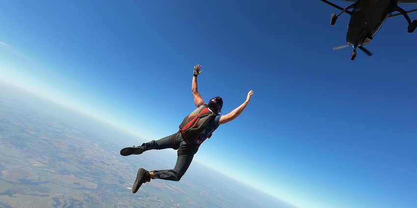 An image of a man jumping backwards from the aircraft