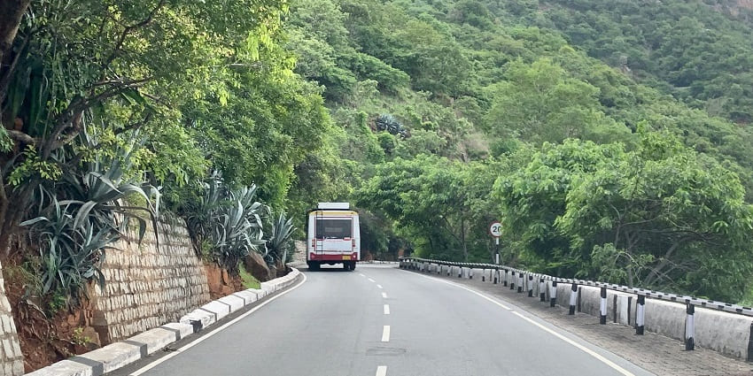 Road with green surroundings in Andhra Pradesh passing through the hills and forest.