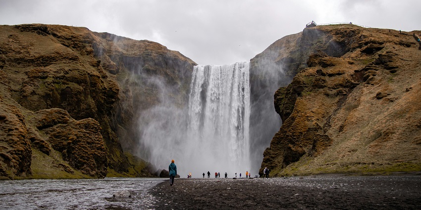 A picture of the Changey Waterfalls with the tall hiking mountains in the background