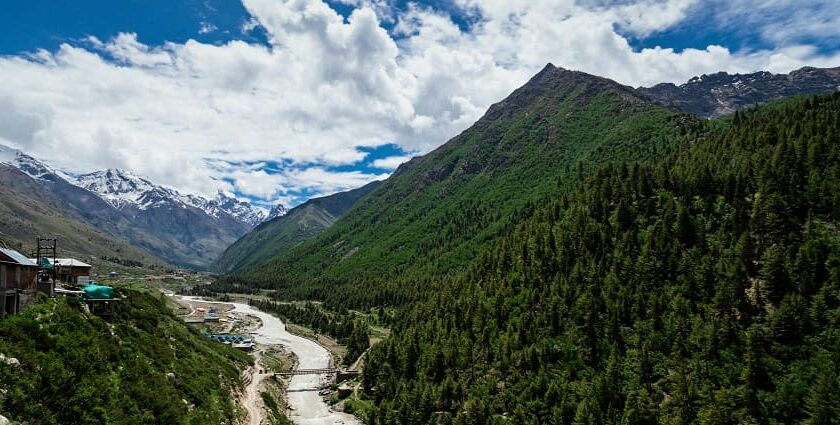 Image of river running through lush green mountains - hill stations near Ludhiana