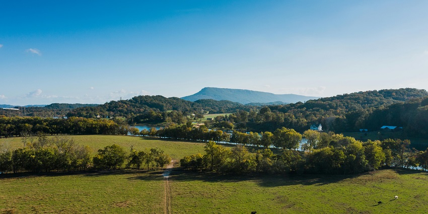 Picturesque hilly village with charming houses nestled among lush green hills.