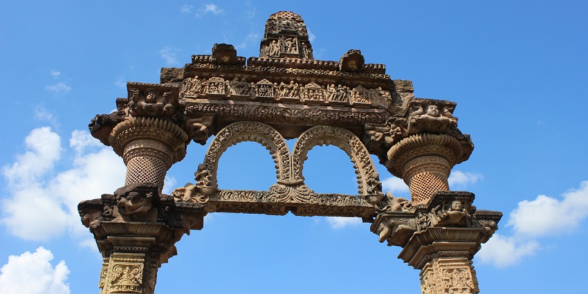 An image view of the Hindola Torana, showcasing intricate carvings and unique sloping arches.