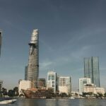 A glimpse of shimmering waters with a backdrop of towering buildings in Vietnam.