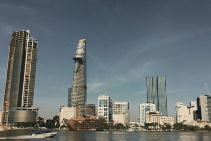 A glimpse of shimmering waters with a backdrop of towering buildings in Vietnam.