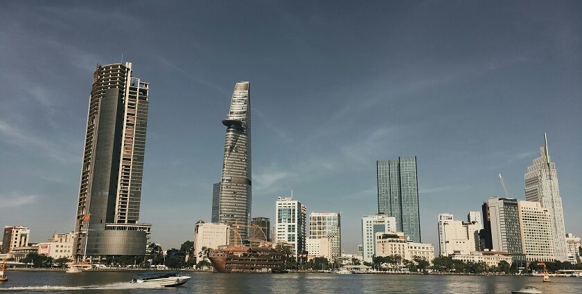 A glimpse of shimmering waters with a backdrop of towering buildings in Vietnam.