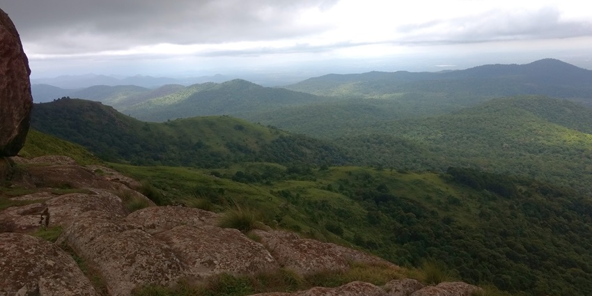 Image of the panoramic view from Honnametti Kallu with greenery and twisty roads