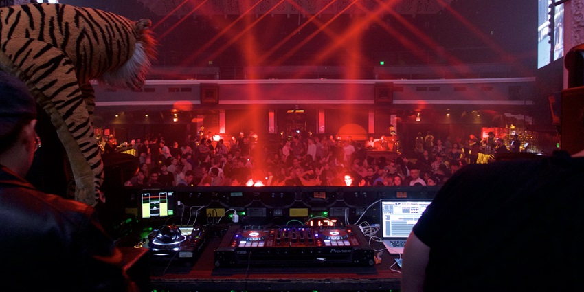 A picture of a nightclub in the Hotel Embassy with a DJ entertaining the crowd