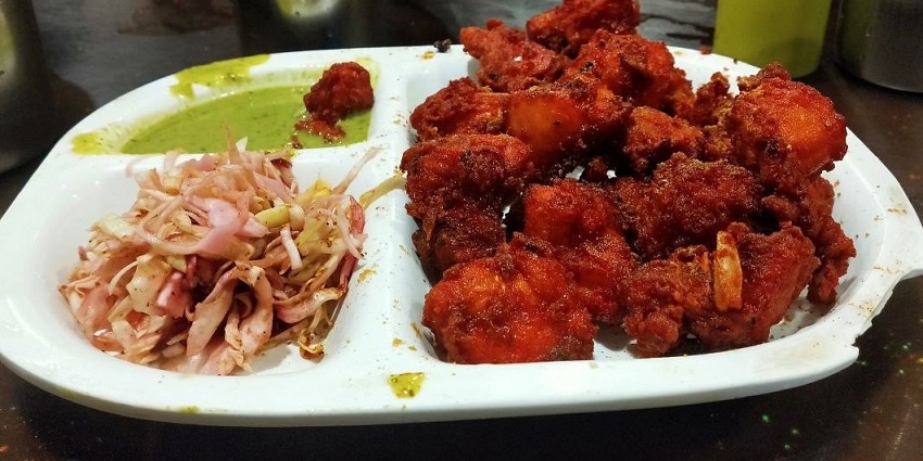 A lip-smacking view of a plate containing Indian folk cuisine for travellers in Dwarka.