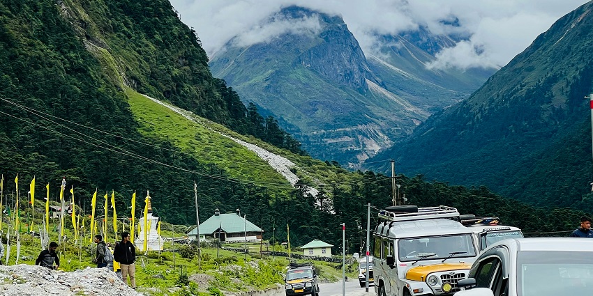 A fascinating view of lush green mountains with a roading passing through during the day.