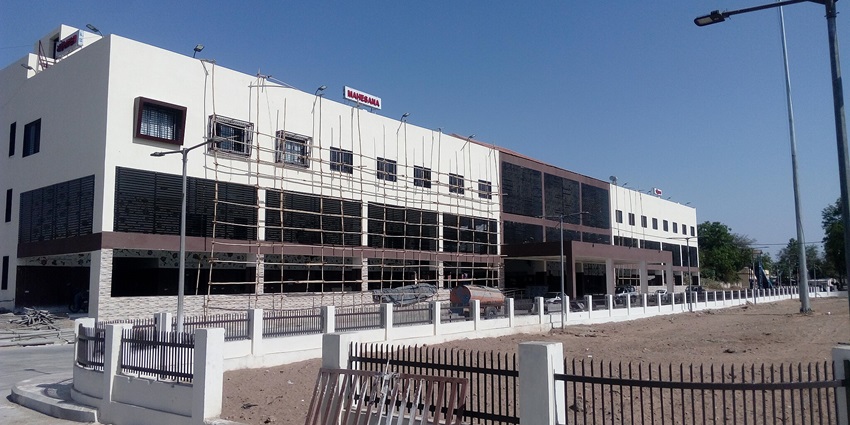 Mahesana New Railway Station with a white building and many people, near Shanku Water Park, Mehsana.