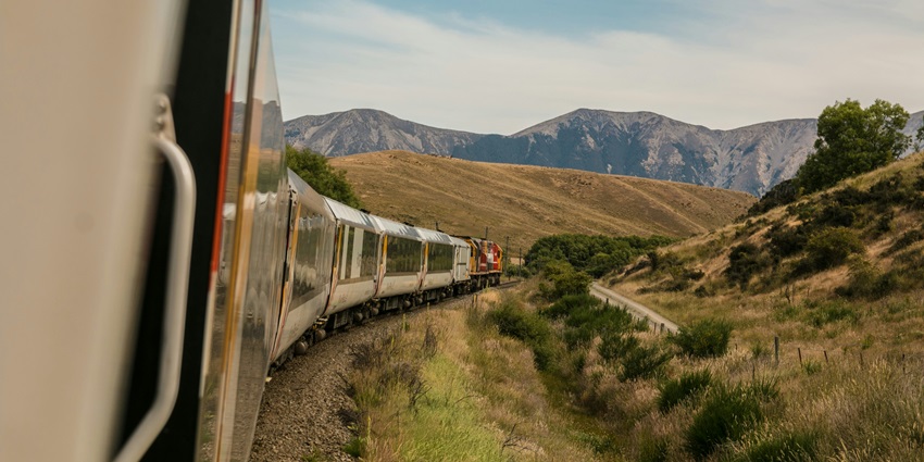 Image of a train going through lush green hills - Nearest railway to Kammasandra