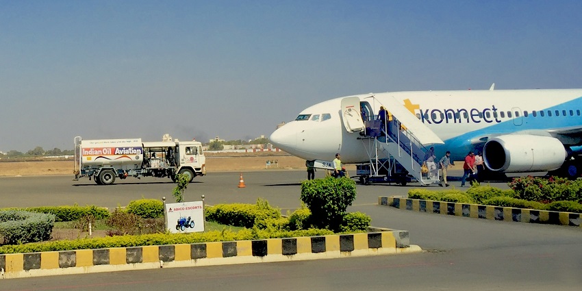 Rajkot airport with a modern terminal and runway, ready for arriving flights.