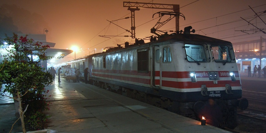 Bhopal Railway Station, a way to reach the Salkanpur Temple, featuring a busy street with traffic and pedestrians.