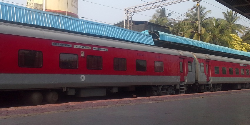 A picture of a train arriving at a railway station