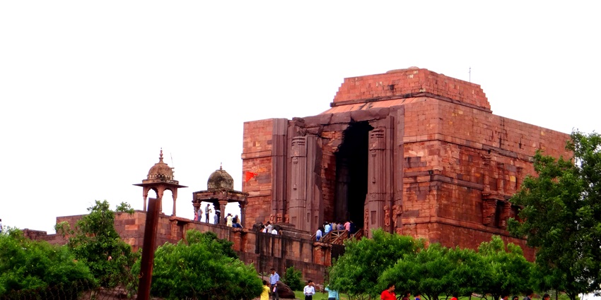 An image showing a bustling entrance brimming with enthusiastic devotees and activity.