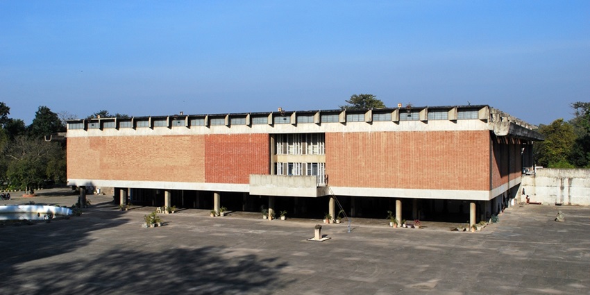 A picture of a red building taken from the front with on a bright sunny day