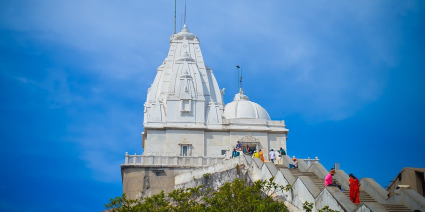 Picturesque view of the incarved temple roof against the clear blue sky