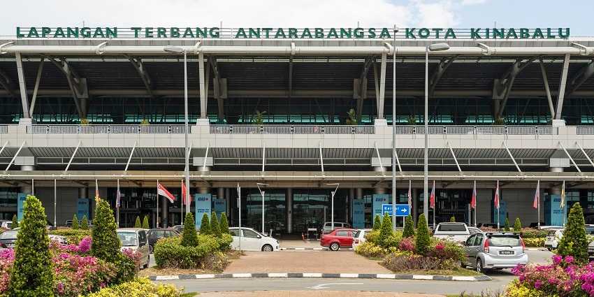 Image of Kota Airport, stunning architecture, with front lush green garden and cars parked