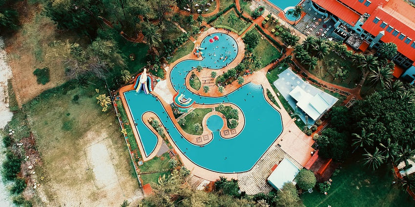 An aerial view of the Raj water park and resort with its swimming pool and greenery visible