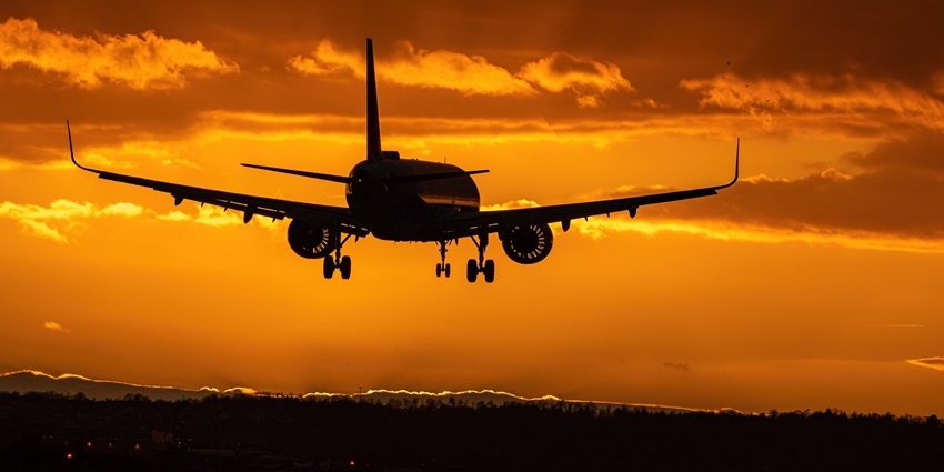 A picture of an aeroplane taken during the twilight hour