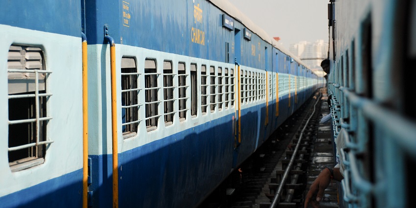 A picture of a blue train running on a track, going towards the nearest railway station to Ajatshatru Fort
