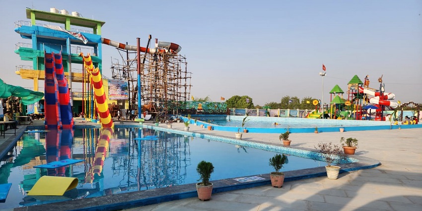 Distant view of water slides and a crystal clear swimming pool
