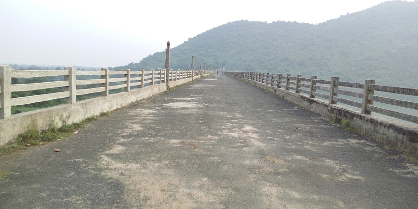 Bridge featuring a protective fence, leading towards the entrance of Balda Caves Odisha.