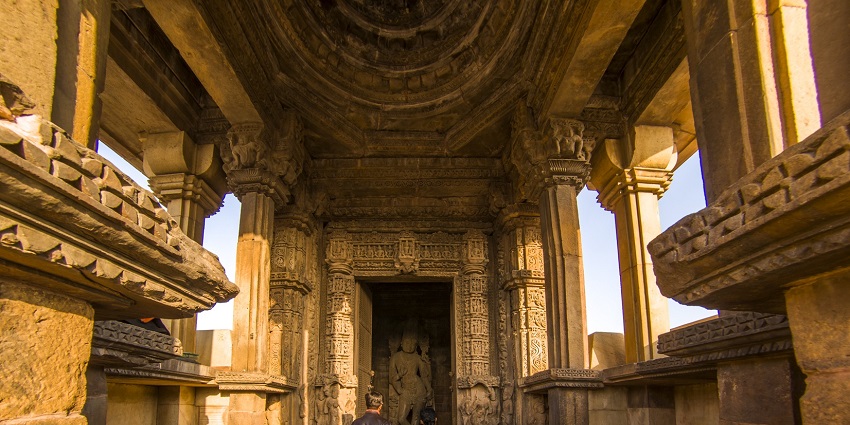 The interior of Chaturbhuj Temple showcases stone pillars, detailed carvings, and soft natural light.

