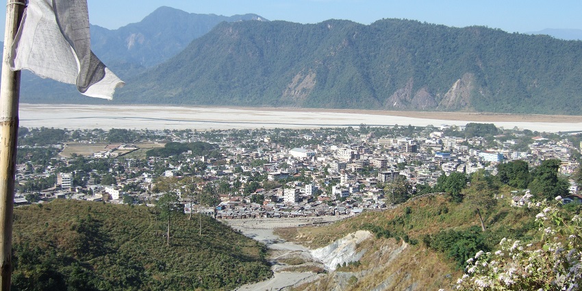 A panoramic view of Phuentsholing town in Bhutan, capturing the bustling place and surrounding lush landscapes.
