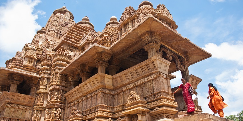 A photo of the temple taken from a slightly low angle shows two women ascending the stairs.