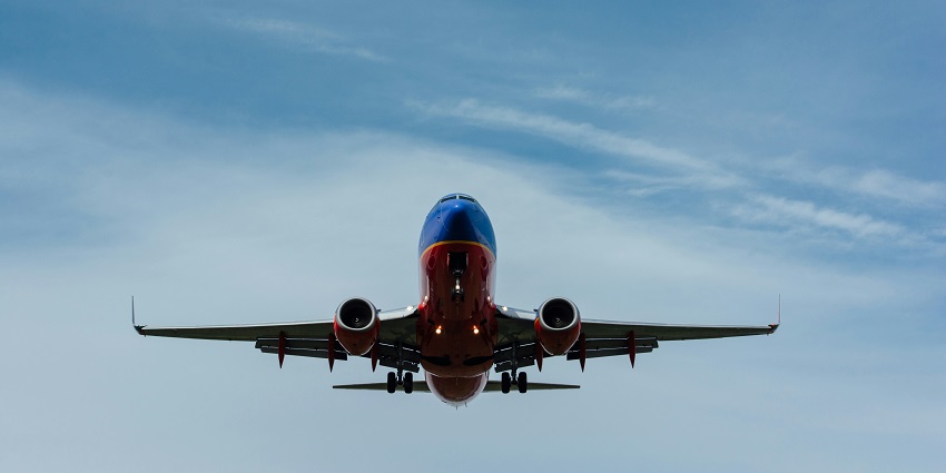 A marvellous view of an airplane in the sky with dense clouds during the daytime.