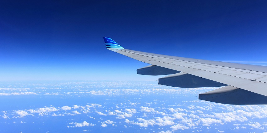 A breathtaking view of dense clouds from an aeroplane window during the daytime.