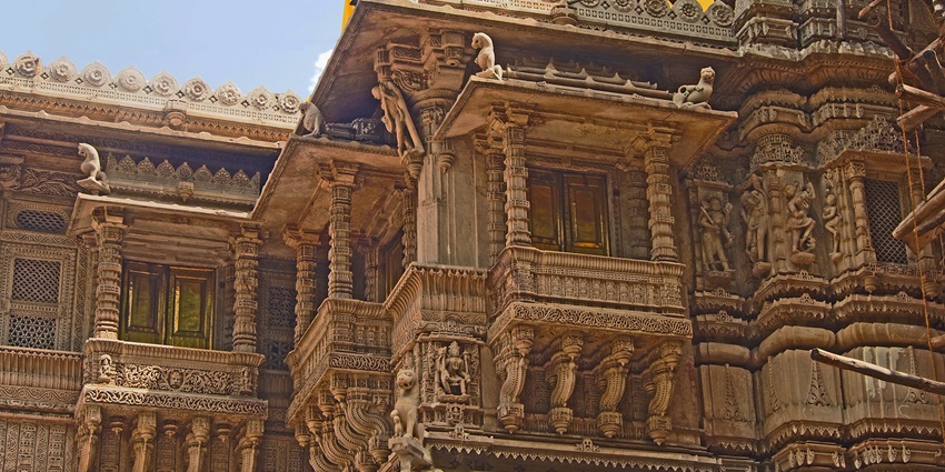 The famous Jain temples in Gujarat feature intricate carvings on the exterior walls.