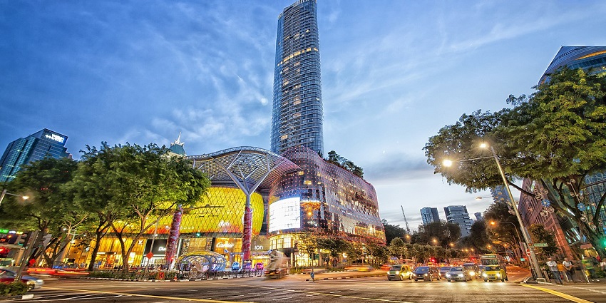 Vibrant view of ION Orchard shopping mall in Singapore, with its sparkling glasses and bustling entrance