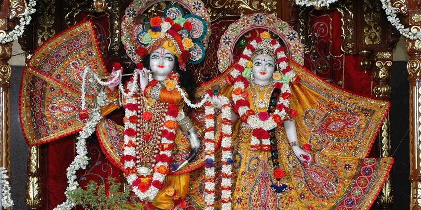 Serene temple promotes Krishna's teachings, yoga, meditation, and community activities.