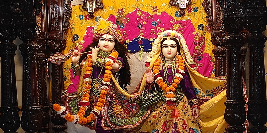 A frontal view of the decorated idols of Lord Krishna and Radha Rani at a Krishna temple in Delhi