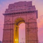 Evening view of India Gate, illuminated against a twilight sky - nightlife in Delhi.