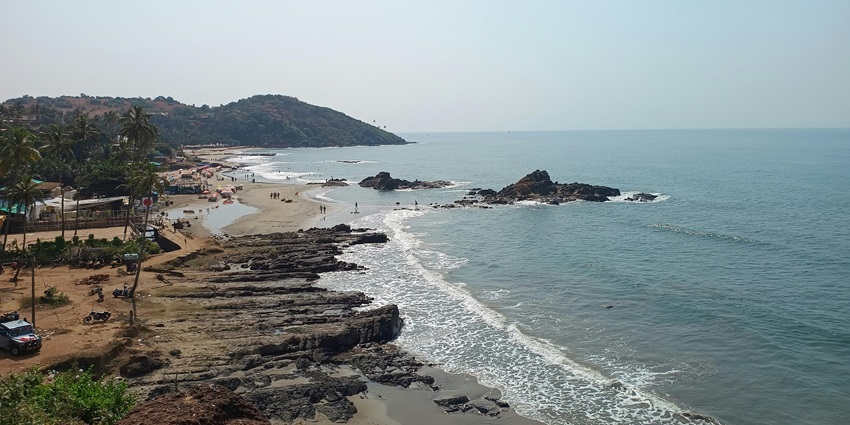 Scenic view of the Baga Beach, with waves crashing the sandy shores