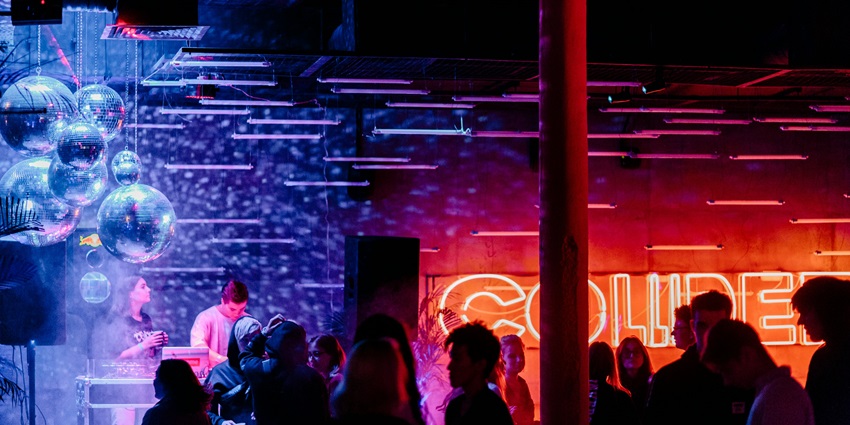 An image of people enjoying under the neon light in Insanity Nightclub in Bangkok