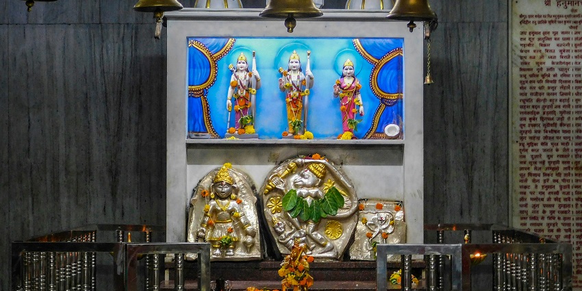 A shelf dedicated to lord hanuman and ram and bells hanging - hanuman temples in delhi.