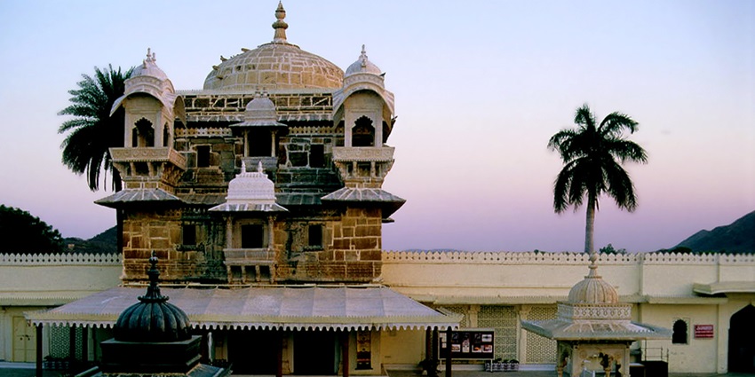 Island palace of Jag Mandir with domes and archways floating in Lake Pichola.