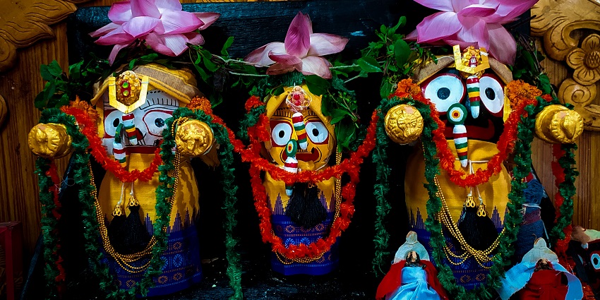 Idols of Jagannath, Balabhadra, and Subhadra are decorated with colourful flowers.