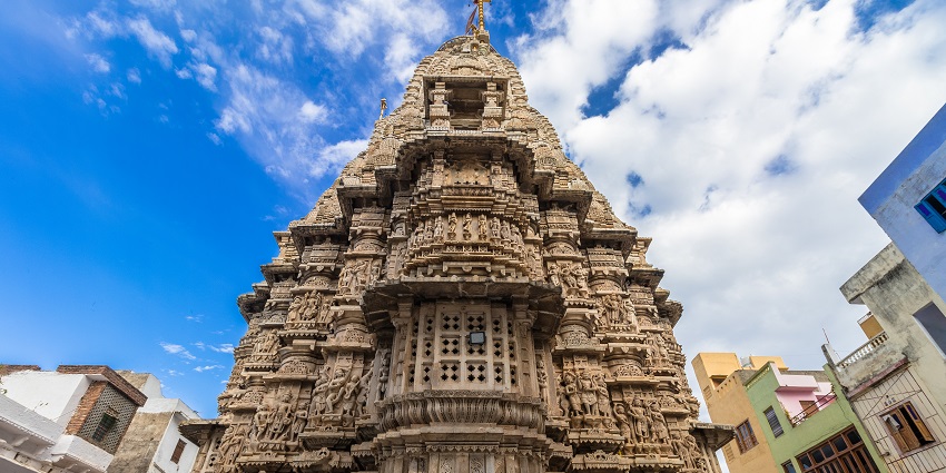 Magnificent Jagdish Temple with intricate architecture shining under a clear blue sky.