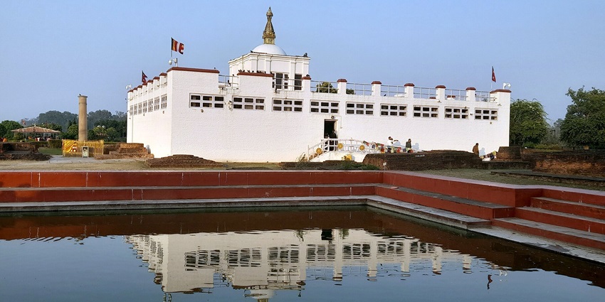 An image showing a magical view of the Jainti Devi temple covered with greenery and mountains all around.