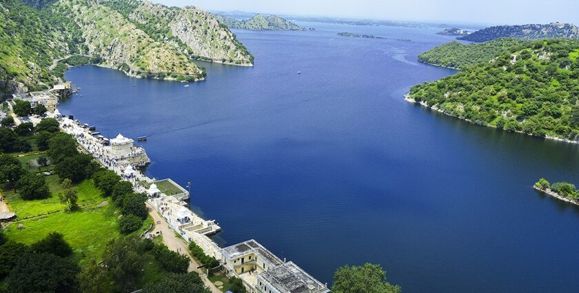 A serene view of Jaisamand Lake, surrounded by the dense greenery of Jaisamand Wildlife Sanctuary