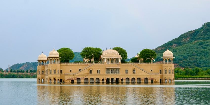 A breathtaking view of Jal Mahal shimmering on Man Sagar Lake, during the daytime.