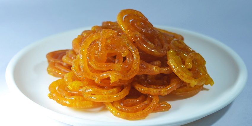 Jalebi, a deep-fried spiral-shaped dessert soaked in a sugar syrup, is a must-try dish.