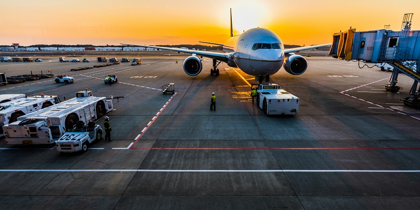 A daytime shot of a runway view of Jamnagar Airport with a plane ready for takeoff.